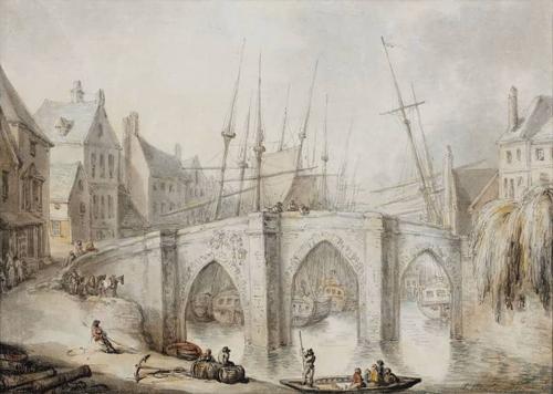 A bridge over a river in a town, with shipping moored