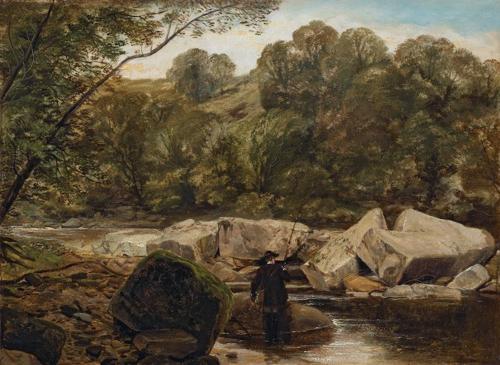 An angler by the rocks in a river landscape with trees